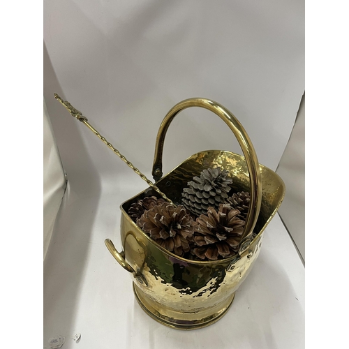 75 - A VINTAGE HAMMERED EFFECT BRASS COAL BUCKET FILLED WITH PINE CONES