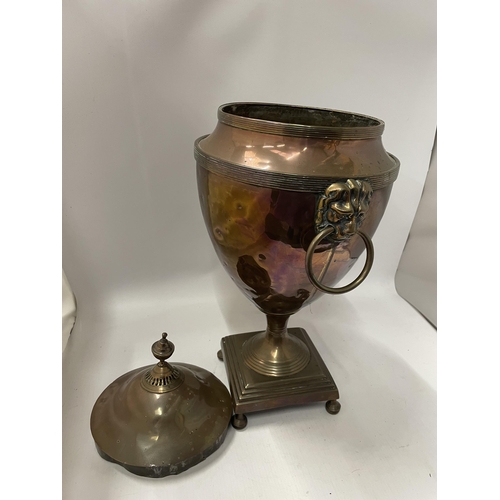 83 - AN EARLY 20TH CENTURY COPPER SAMOVAR WITH LION DESIGN HANDLES