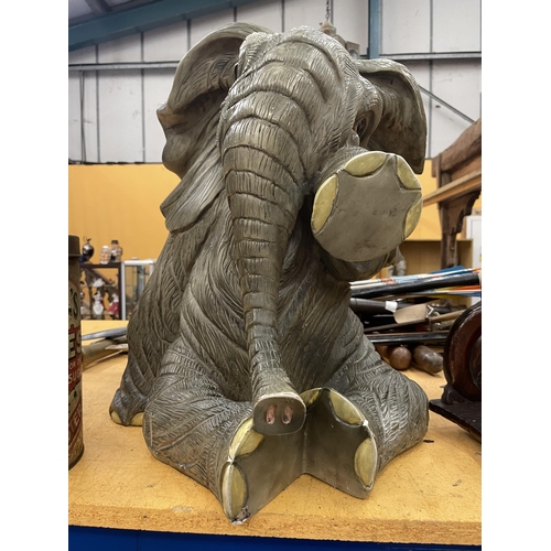 86 - A LARGE MODEL OF A SEATED ELEPHANT