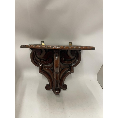 87 - A VINTAGE CARVED OAK SHELF