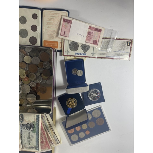 377 - TIN CONTAINING AN ASSORTMENT OF WORLD COINS AND BANKNOTES , TO INCLUDE CHINA , FALKLANDS , IOM