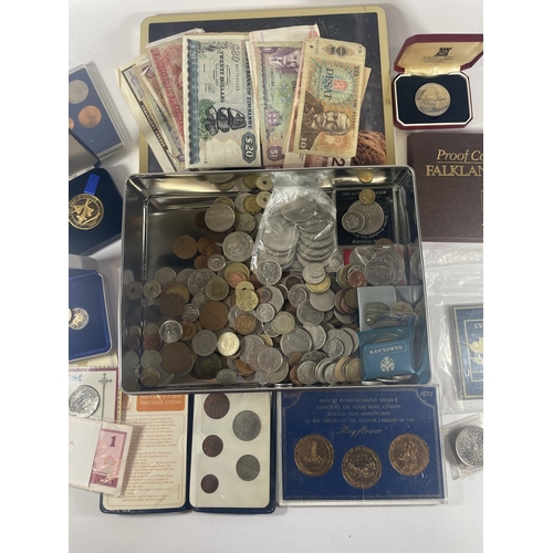 377 - TIN CONTAINING AN ASSORTMENT OF WORLD COINS AND BANKNOTES , TO INCLUDE CHINA , FALKLANDS , IOM