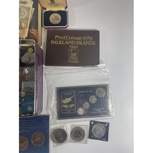 377 - TIN CONTAINING AN ASSORTMENT OF WORLD COINS AND BANKNOTES , TO INCLUDE CHINA , FALKLANDS , IOM