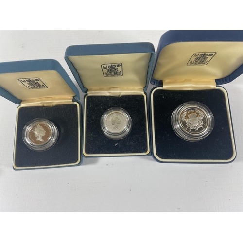 437 - UK A SELECTION OF PIEDFORT SILVER PROOF COINS . 1985 £1 , 1986 £1 , 1986 £2 ALL BOXED