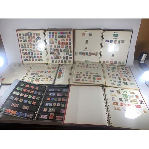 450A - SEVEN ALBUMS CONTAINING STAMPS FROM AROUND THE WORLD AND VARIOUS LOOSE STAMPS ETC