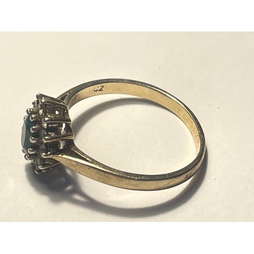 514 - A 9 CARAT GOLD RING WITH CENTRE GREENSTONE SURROUNDED BY CUBIC ZIRCONIAS SIZE P