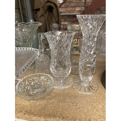 1030 - A LARGE QUANTITY OF GLASSWARE TO INCLUDE A CAKE STAND, TRINKET POT, VASES, CANDLESTICK ETC.,