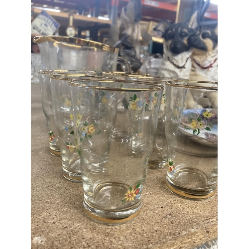 1066 - A VINTAGE GLASS LEMONADE SET FLORAL WITH GOLD RIM