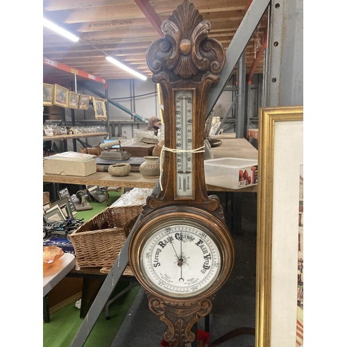 1108 - A VINTAGE CARVED MAHOGANY CASED ANEROID BAROMETER