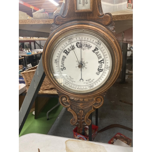 1108 - A VINTAGE CARVED MAHOGANY CASED ANEROID BAROMETER