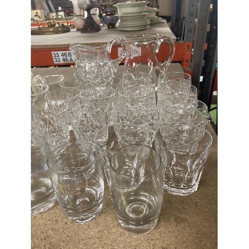 1129 - A QUANTITY OF GLASS TUMBLERS AND TWO WATER JUGS