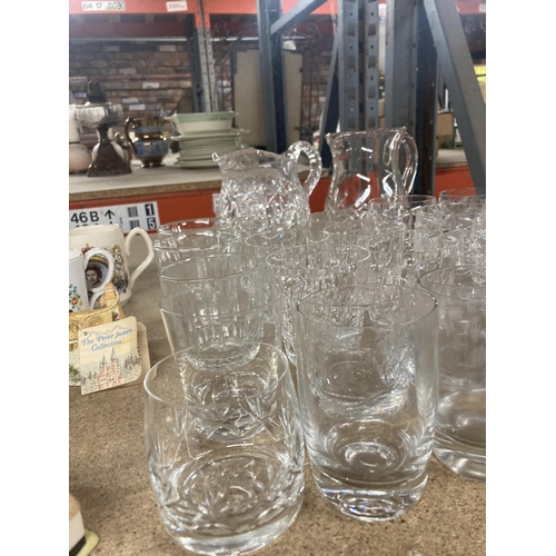 1129 - A QUANTITY OF GLASS TUMBLERS AND TWO WATER JUGS