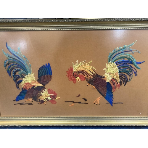 1305 - A LARGE GILT FRAMED WOOLWORK PICTURE OF FIGHTING COCKS 93CM X 57CM