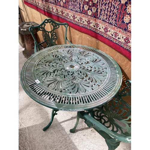 1582 - A CAST ALLOY BISTRO SET COMPRISING OF A ROUND TABLE AND TWO CARVER CHAIRS