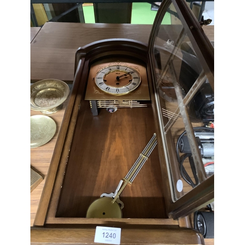 1240 - A HERMLE PENDULUM WALL CLOCK ENCASED IN MAHOGANY AND GLASS PANEL