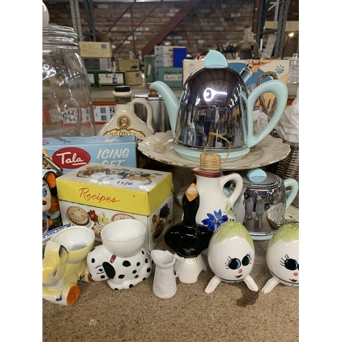 1126 - A MIXED LOT TO INCLUDE NOVELTY EGGCUPS, A STINLESS STEEL AND CERAMIC RETRO TEAPOT, ICING SETS, RECIP... 