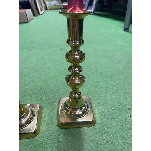 1017A - TWO PAIRS OF VINTAGE BRASS CANDLESTICKS WITH CANDLES