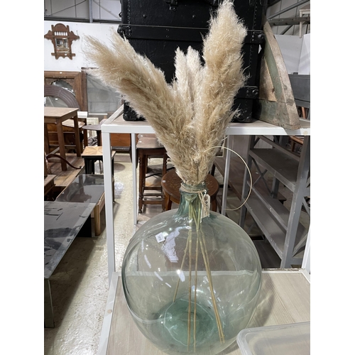 3858 - A BULBOUS GLASS DISPLAY WITH FEATHERS