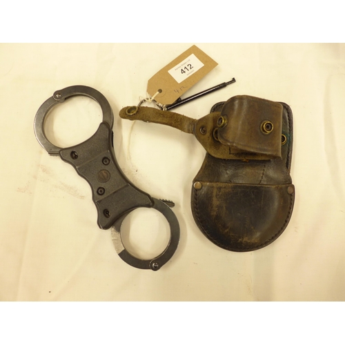 412 - A PAIR OF SPEED POLICE HANDCUFFS, KEY AND LEATHER CASE