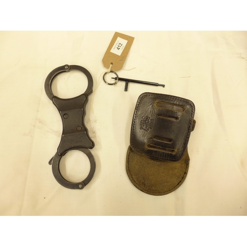 412 - A PAIR OF SPEED POLICE HANDCUFFS, KEY AND LEATHER CASE