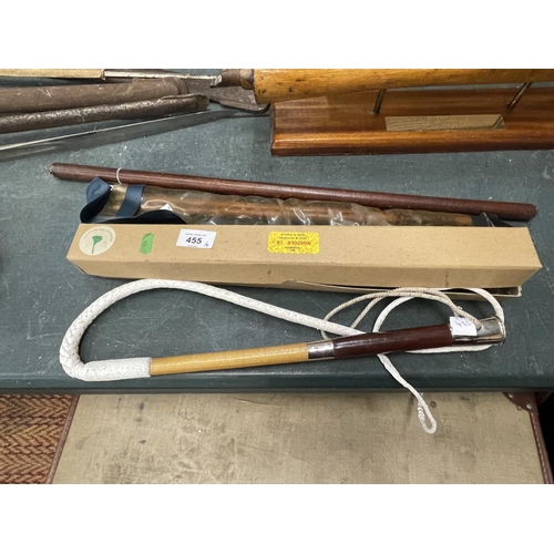 455 - A LEATHER SWAGGER STICK, TWO GUN CLEANING KITS AND A WHIP