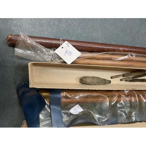 455 - A LEATHER SWAGGER STICK, TWO GUN CLEANING KITS AND A WHIP