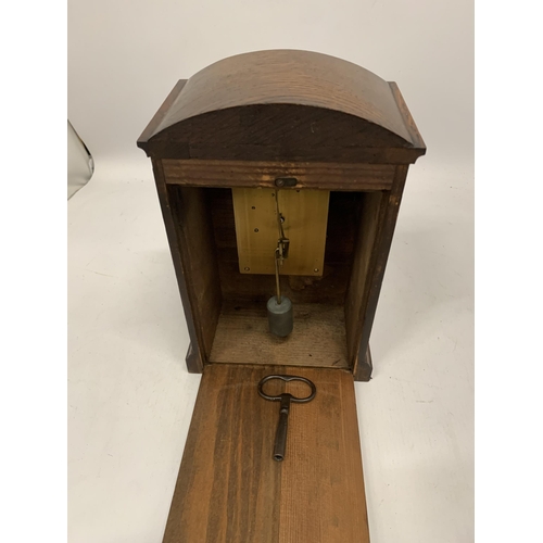 212 - A VINTAGE GERMAN OAK MANTLE CLOCK