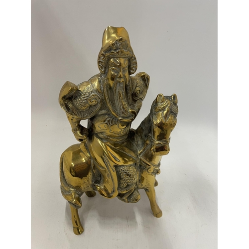 242 - AN ORIENTAL BRASS FIGURE OF A WARRIOR ON HORSEBACK