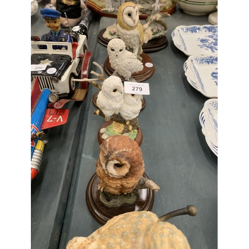 279 - A COLLECTION OF OWL ANIMAL FIGURES ON WOODEN BASES