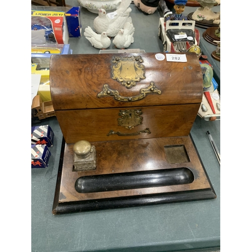 282 - A VINTAGE WALNUT DESK STAND WITH BRASS FITTINGS