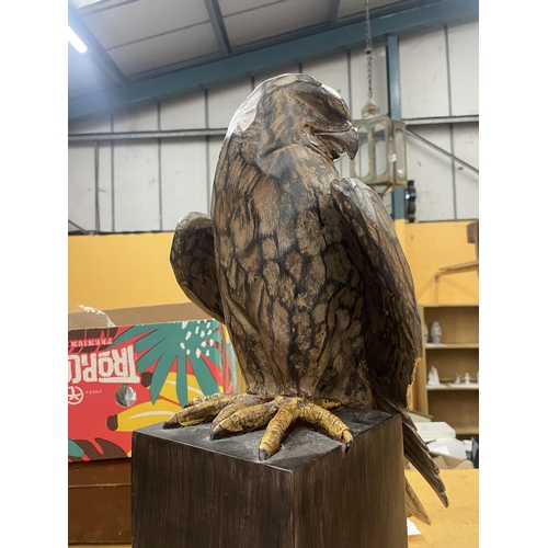 74 - A LARGE WOODEN CARVED EAGLE ON BASE