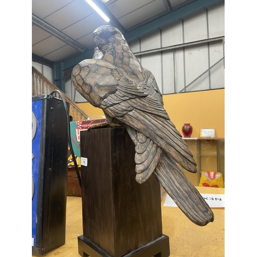 74 - A LARGE WOODEN CARVED EAGLE ON BASE