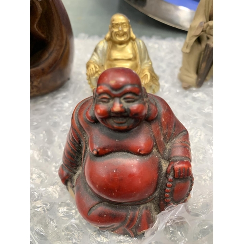 112 - A COLLECTION OF THREE BUDDAHS AND AN ORIENTAL FIGURE GROUP