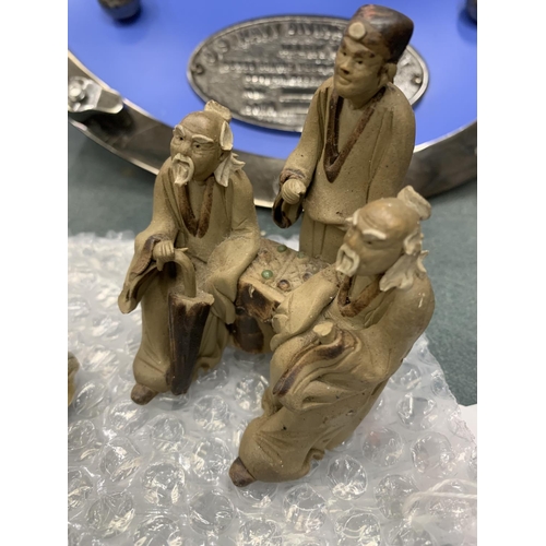 112 - A COLLECTION OF THREE BUDDAHS AND AN ORIENTAL FIGURE GROUP