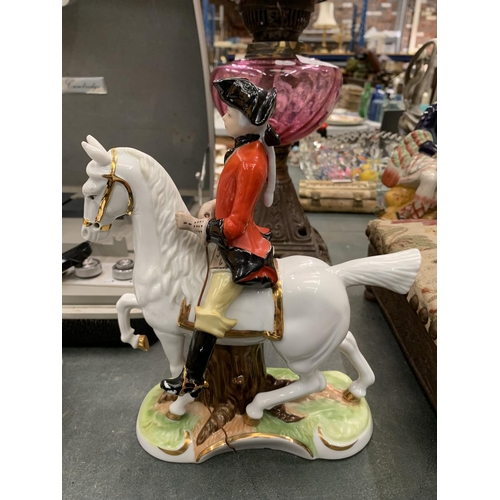 121 - TWO CERAMIC FIGURES OF A MAN AND LADY OUT RIDING HEIGHT 21CM