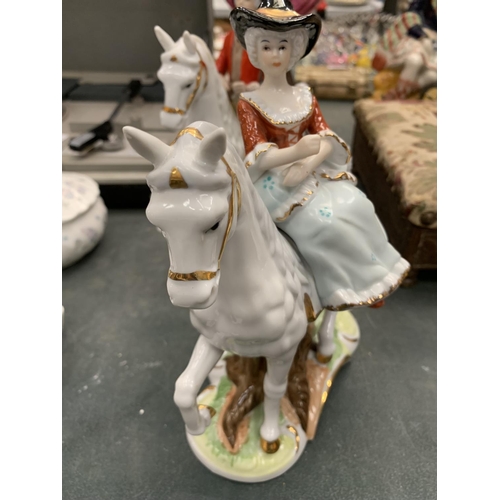 121 - TWO CERAMIC FIGURES OF A MAN AND LADY OUT RIDING HEIGHT 21CM