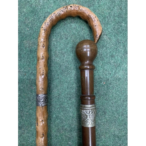 128 - TWO VINTAGE WALKING STICKS WITH WHITE METAL COLLARS, ONE IS INSCRIBED SIMEON GRUNDY, 1875 AND HAS A ... 