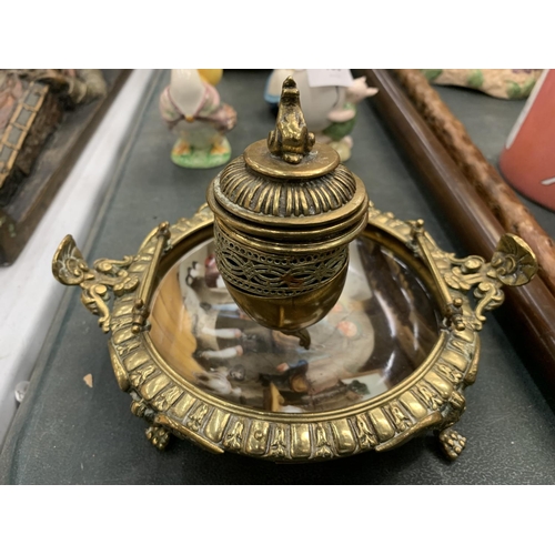 129 - A BRASS INKWELL WITH A CERAMIC BASE