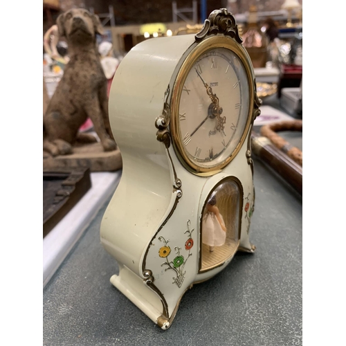 131 - MANTLE CLOCK WITH ALARM IN PALE GREEN WITH FLORAL DECORATION AND A BALLERINA FIGURE HEIGHT 15CM