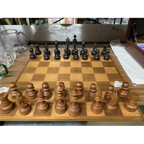 1138 - A LARGE WOODEN CHESSBOARD WITH A FULL SET OF WOODEN CHESS PIECES