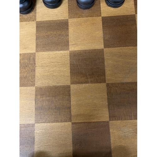 1138 - A LARGE WOODEN CHESSBOARD WITH A FULL SET OF WOODEN CHESS PIECES