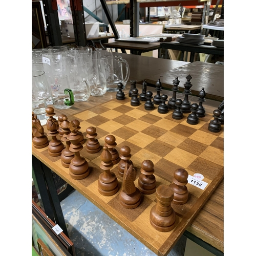 1138 - A LARGE WOODEN CHESSBOARD WITH A FULL SET OF WOODEN CHESS PIECES