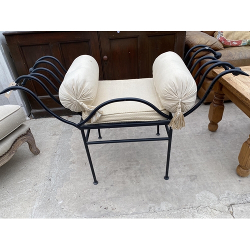 2987 - A BLACK CAST METAL STOOL WITH ROLLED ARMS AND TWO END CUSHIONS