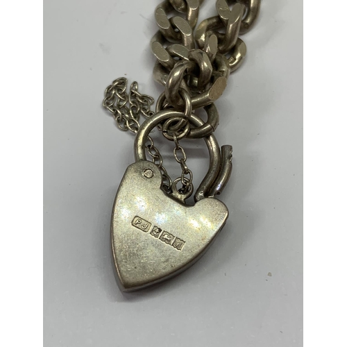 591 - A SILVER WRISTCHAIN WITH HALLMARKED BIRMINGHAM HEART SHAPED PADLOCK