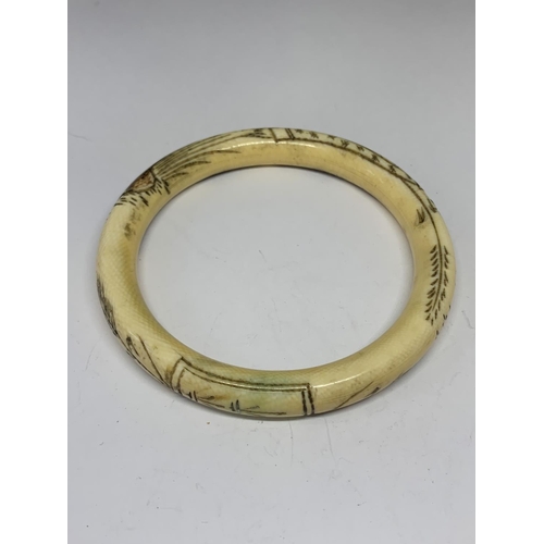 608 - AN ORIENTAL BONE BANGLE