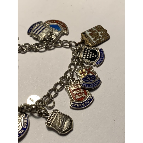 612 - A SILVER CHARM BRACELET WITH EIGHTEEN CITY AND PLACES CHARMS