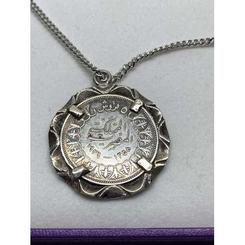 638 - A SILVER NECKLACE WITH AN ORIENTAL COIN PENDANT IN A PRESENTATION BOX