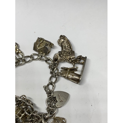 642 - A SILVER CHARM BRACELET WITH TWELVE LARGE CHARMS