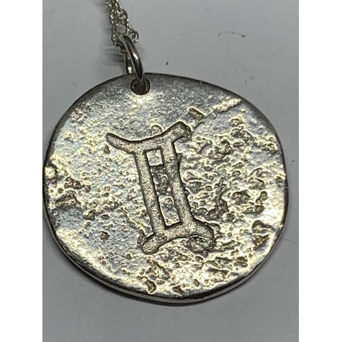 662 - A SILVER NECKLACE WITH ORIENTAL COIN PENDANT IN A PRESENTATION BOX