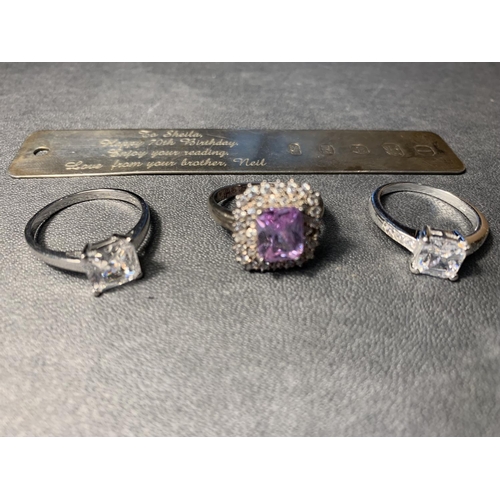 683 - A SILVER INGOT AND THREE SILVER RINGS